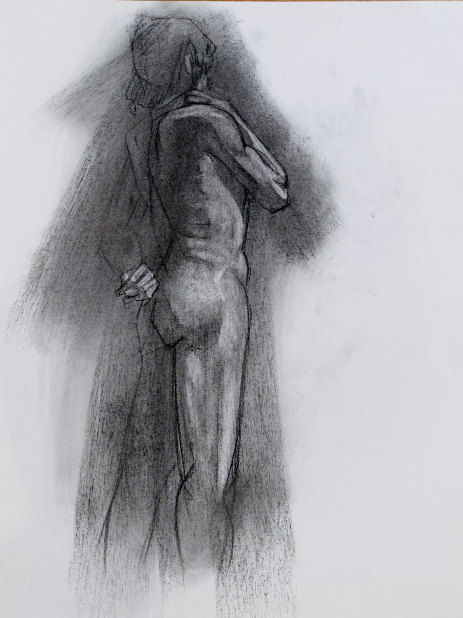 A charcoal drawing of a nude man standing from behind.