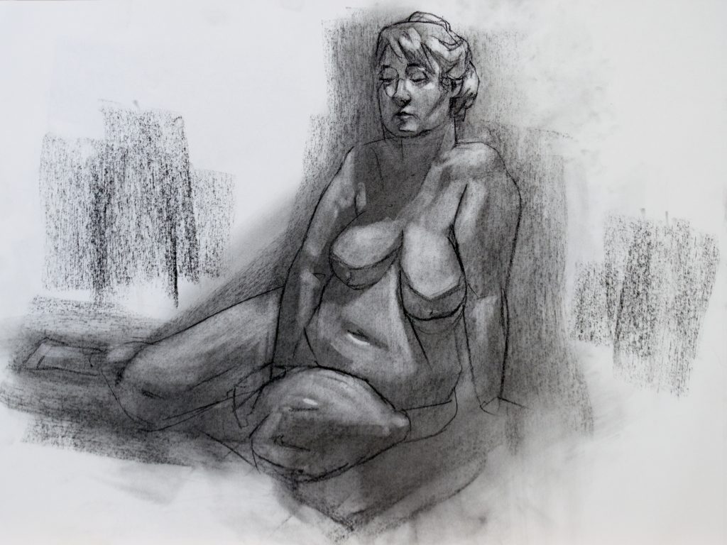A charcoal drawing of a nude woman sitting on the floor.